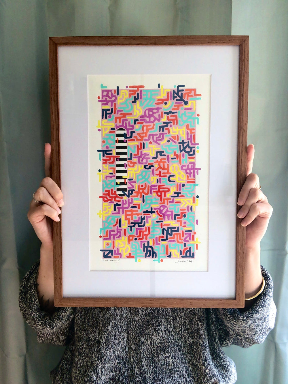 Framed 90's Aerobics gouache pattern artwork held by artist for size reference