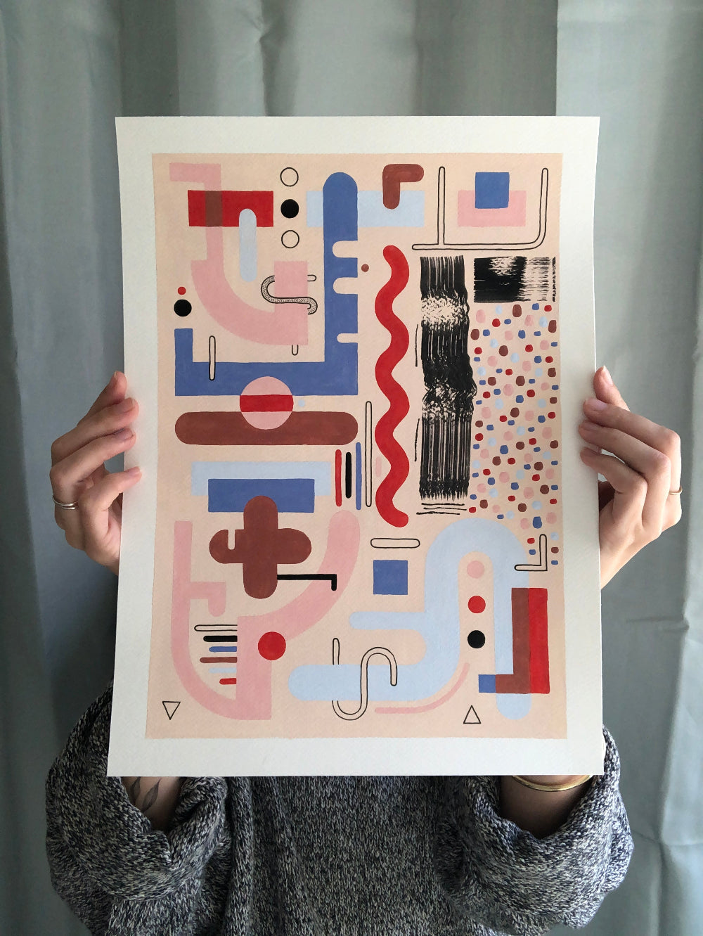 Unframed abstract artwork with gouache and fine liner held by artist for size reference