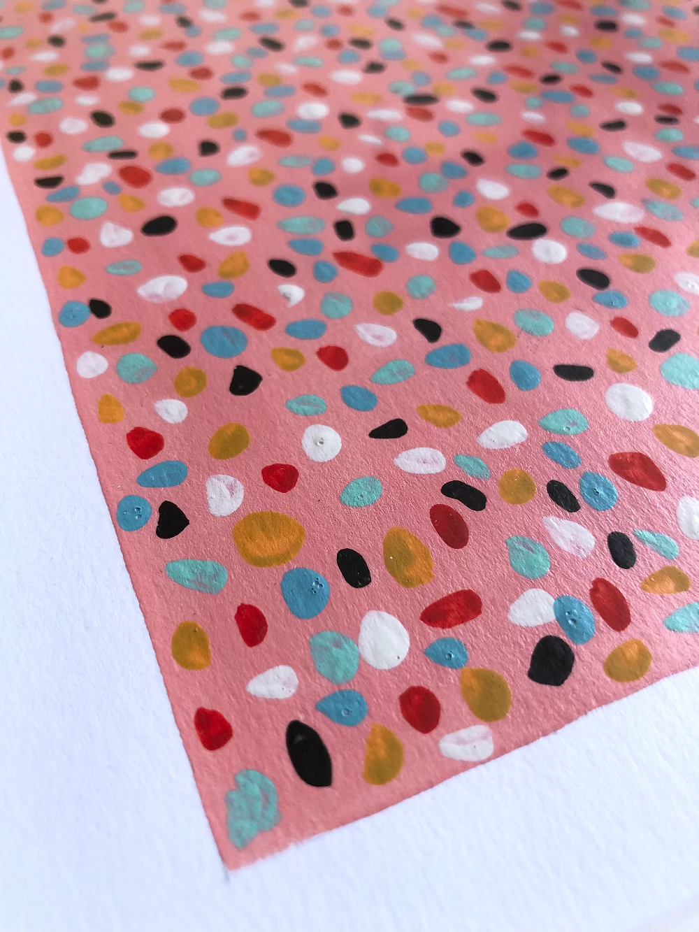 Close up of Pink Lady abstract artwork with colourful dots.