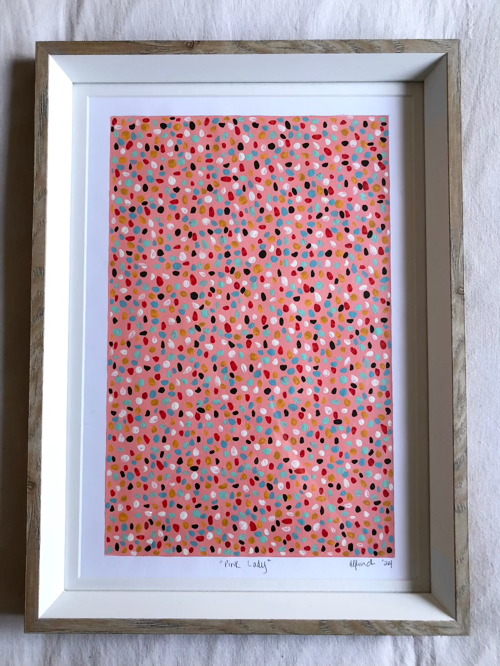 Pink Lady abstract artwork with colourful dots framed.