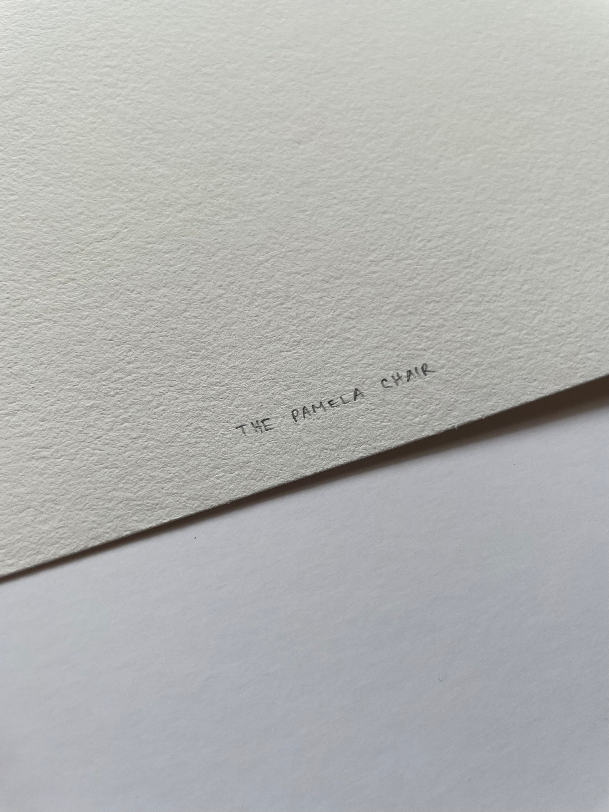Close-up of light textured paper with 'The Pamela Chair' written on it