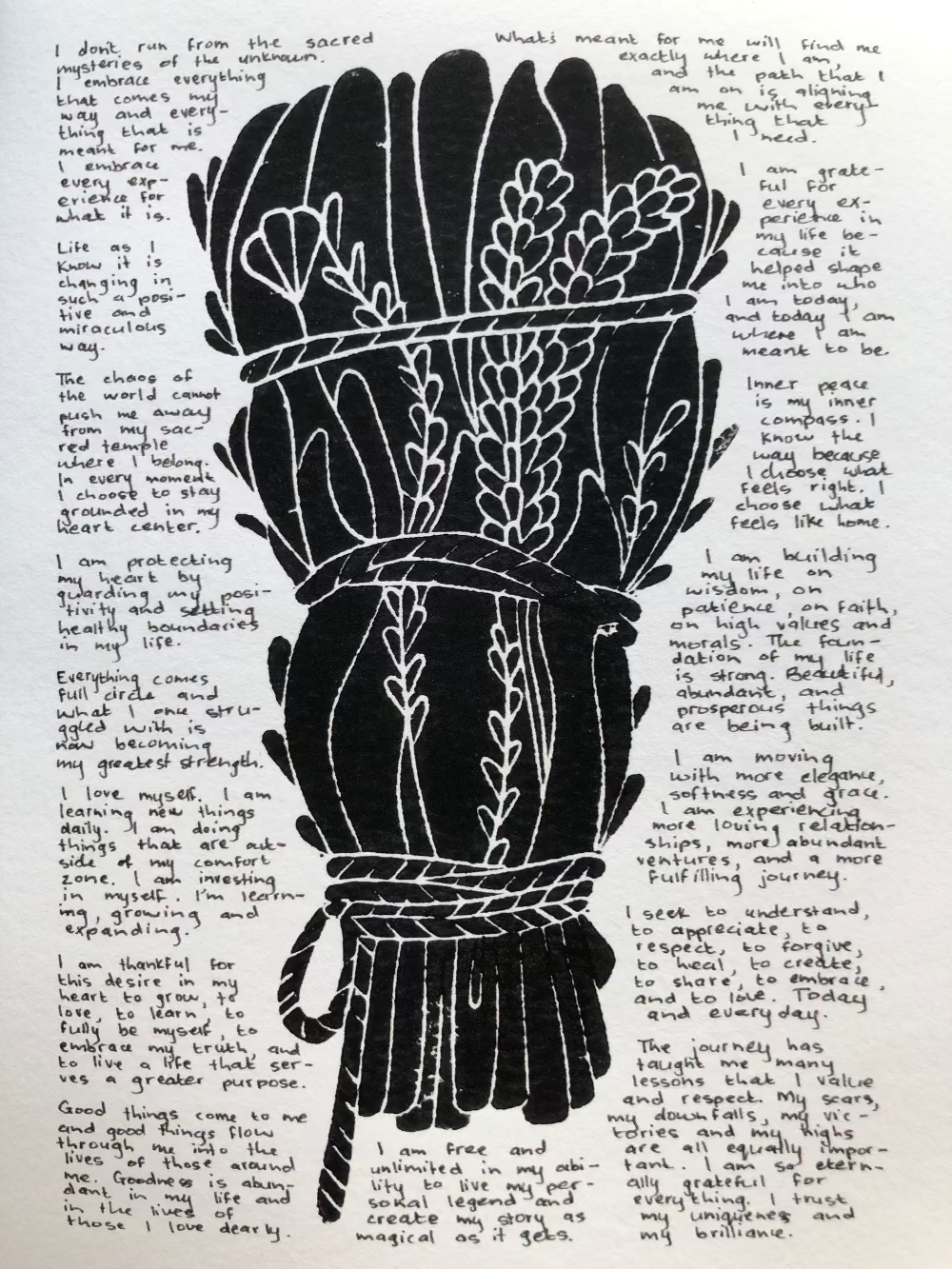 Lino print with tiny handwritten positive affirmations.