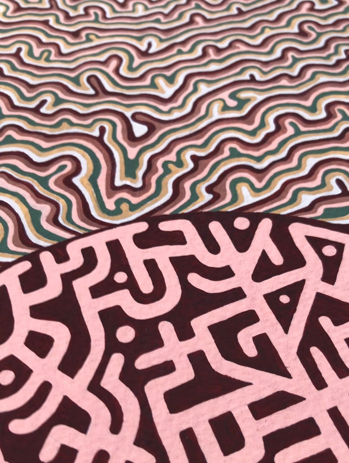 Two distinct abstract patterns in brown and pink on a textured surface.