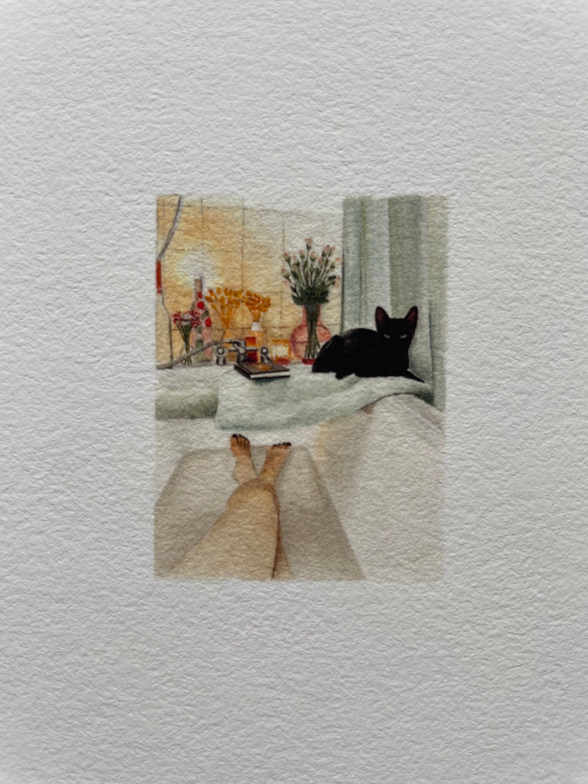 Cat lying on a towel on the bath edge while ladies enjoys a bath